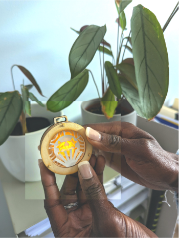 The Lumogram's light is activated by touching the base of the pendant.